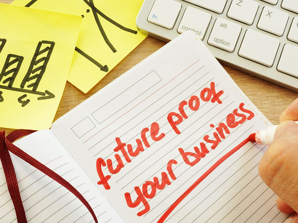 Hand is writing future proof your business.